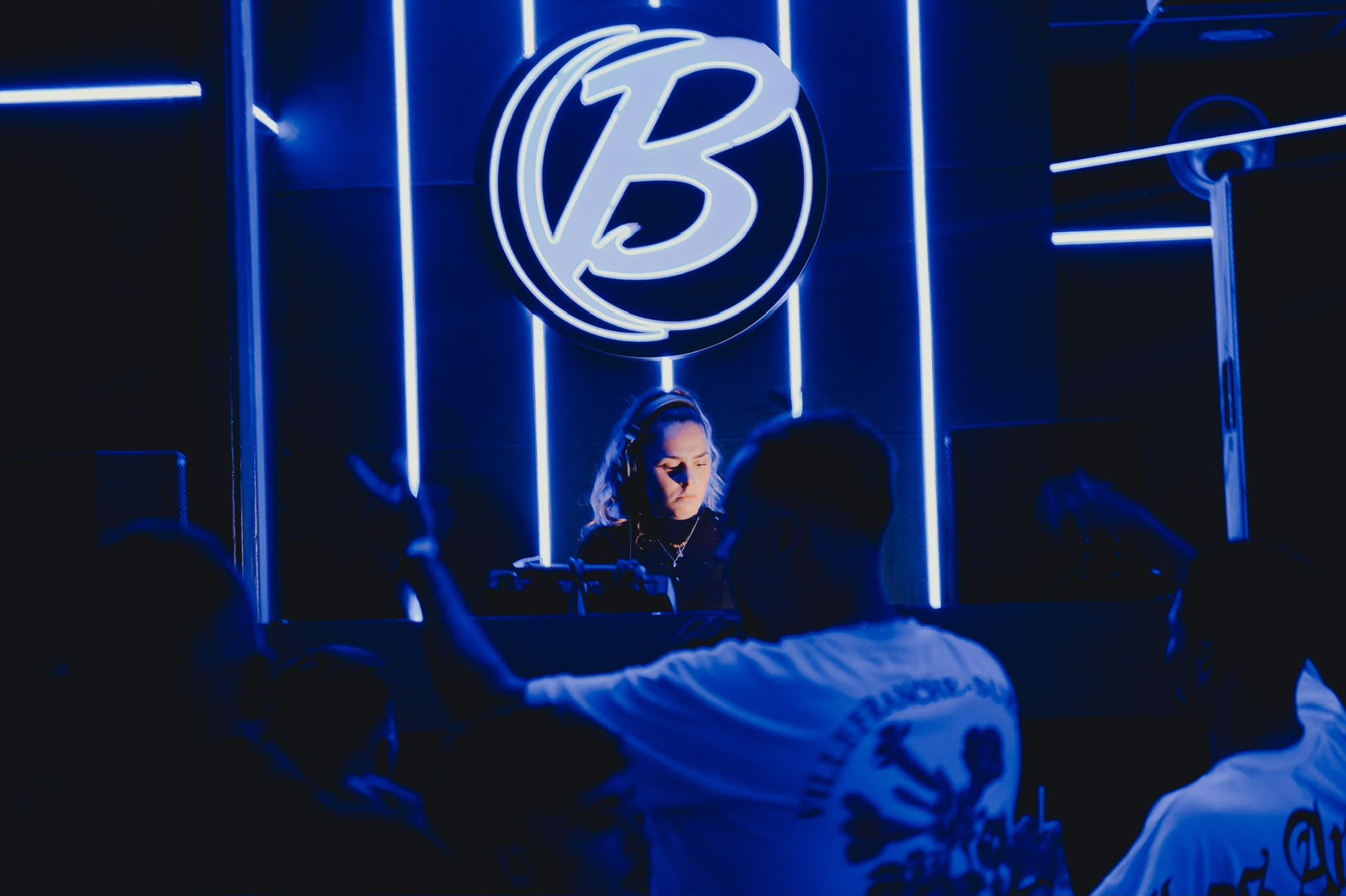 MAR SALVA performing in a blue-lit club with the crowd in front